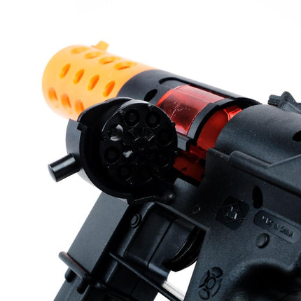 Close-up of black cap gun toy with orange perforated barrel and red loading area