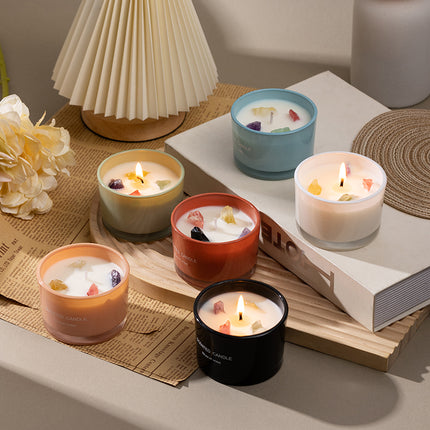 Set of soy wax mood candles with crystal pieces in multiple colors, gift box beside