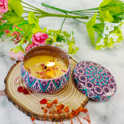 Lavender-scented soy candle in decorative votive tin, lid open, glowing wick