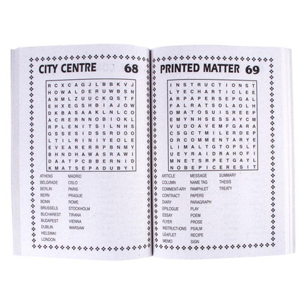 Open word search puzzle book showing printed word grid and city clue lists