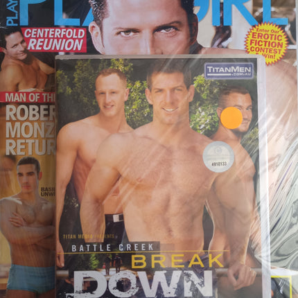 Adult entertainment magazine/DVD in clear cassette case with men cover, blue and orange