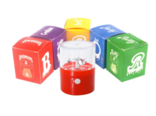 Electric herb grinder boxes in purple, yellow, and green with a red grinding cup