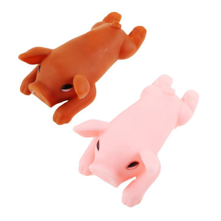 Squeaky pig dog toys, orange and pink plush pigs lying down with visible faces