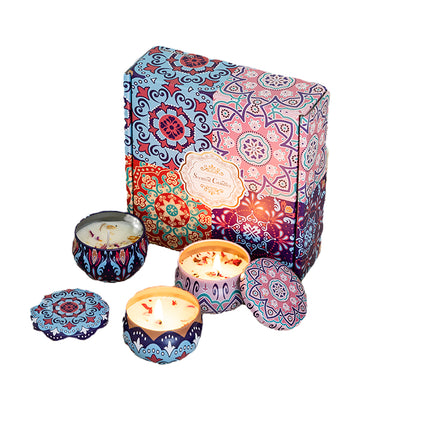 Soy candle gift set: four patterned tins with lids and unlit wax tops