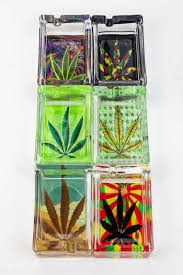 Assorted rectangle glass printed ashtrays, four shown in a stacked display