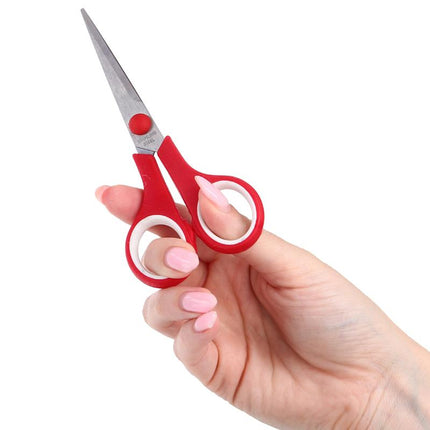 Red scissors held in hand with pointed stainless steel blades