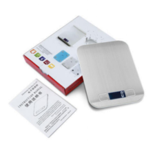 Brushed digital kitchen scale with batteries, manual, and instructions cards