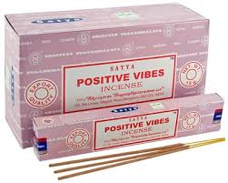 Satya Positive Vibes incense box, pink, with stacked packages and visible sticks