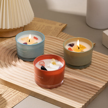 Three soy wax mood candles with crystal wax toppers in blue, red, and tan jars