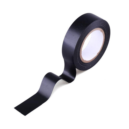 Black electrical tape unrolling from roll with exposed adhesive edge