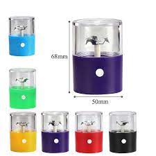 Electric herb grinder cups with clear tops and colored bases (blue, green, yellow, purple, red)