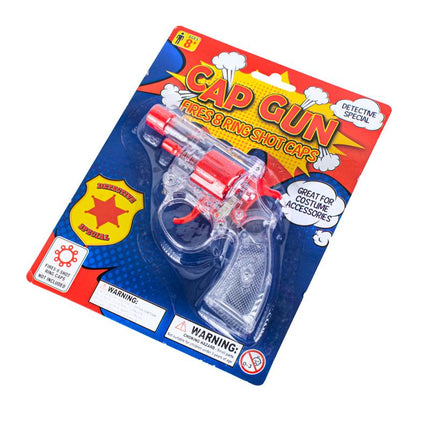 Toy cap gun with clear plastic body and red barrel on blue blister package