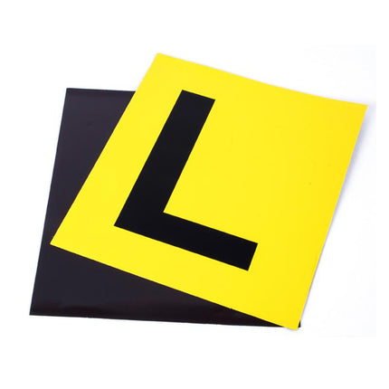 Magnetic L letter plate in bright yellow with black L, tilted over dark backing