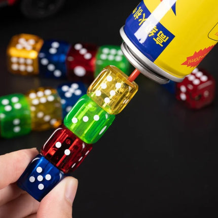 Hand holding gold and green flashing dice jet lighter with glowing LED top