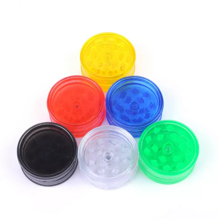 Assorted plastic herb grinder lids in yellow, red, blue, green, clear, and black