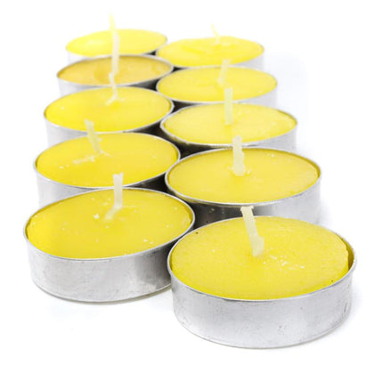 Yellow citronella tealight candles in metal cups with burning wicks
