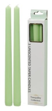 Three lime-green tapered candles in a retail box, scented
