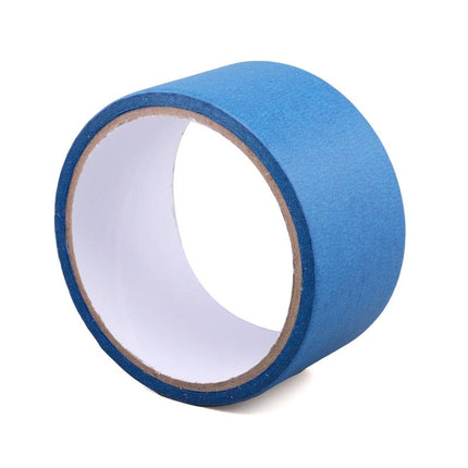 Blue masking tape roll with inner core exposed and paper backing visible