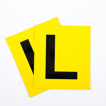 Set of magnetic yellow L letter plates with bold black L symbols, stacked