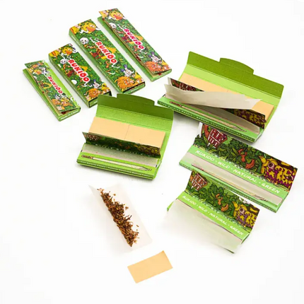 Assorted green rolling paper packs with open trays and loose papers, jungle artwork