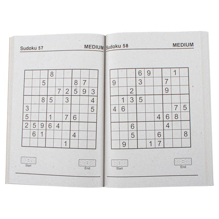 Open Sudoku puzzle book pages with two medium number grids
