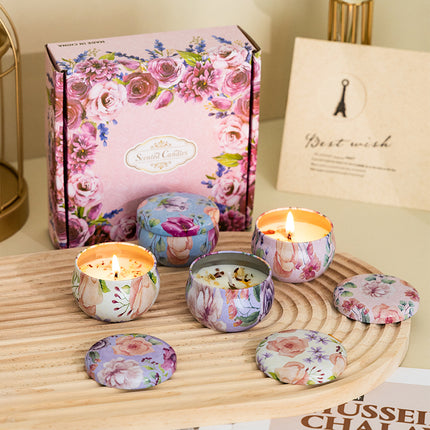 Floral candle gift box with four decorated soy candle tins on wooden tray