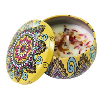 Soy scented candle in decorated votive tin, open lid showing wax and colorful pattern