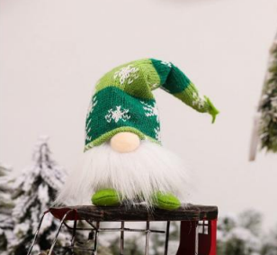 Green Christmas gnome ornament with patterned hat, white beard, and small wooden base