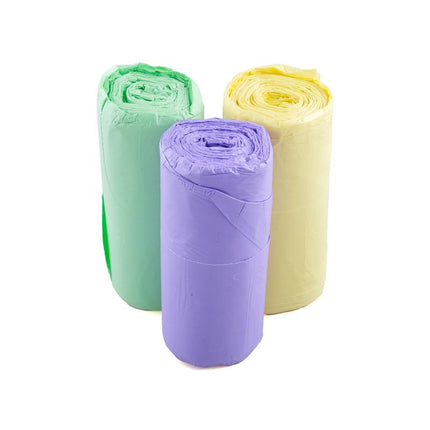Kitchen bin liner rolls, purple, yellow, and green stacked