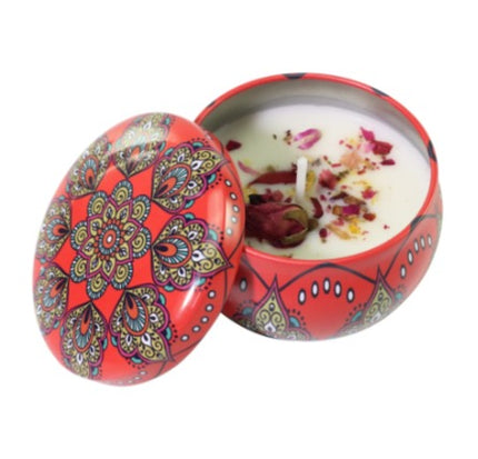 Soy scented candle in votive tin, red patterned lid open.