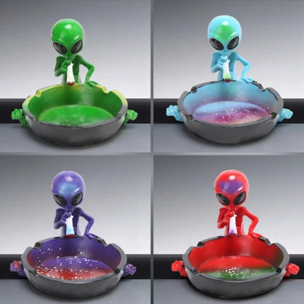 Four alien ashtrays in a grid: green, light blue, purple, and red figurines