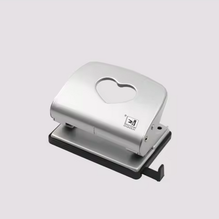 Metal two-hole punch with heart-shaped top opening on silver base.