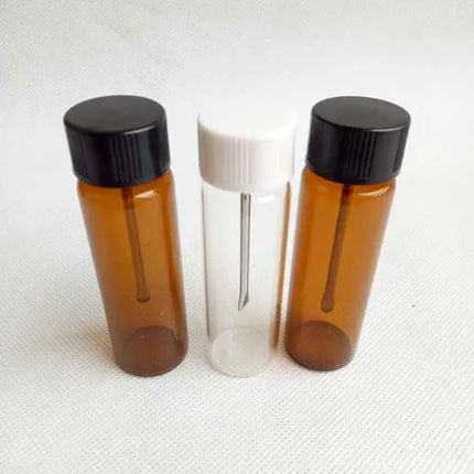 Glass spice canisters in amber and clear with black lids and spoon insert, 3-pack