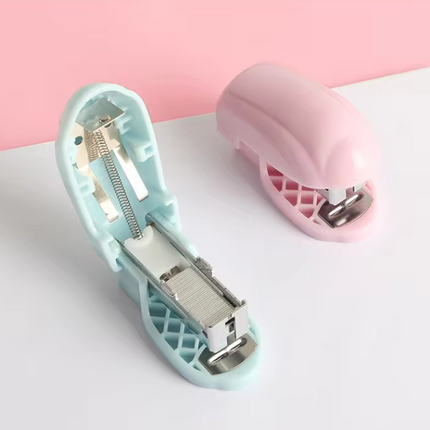 Mini staplers with open interior: light blue and pink, exposed staple channel