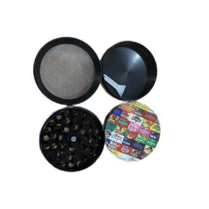 Metal herb grinder with mesh screen tops and dark patterned side lids