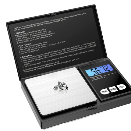 Digital pocket scale with silver plate, blue LCD, and small gemstone on the weighing surface.