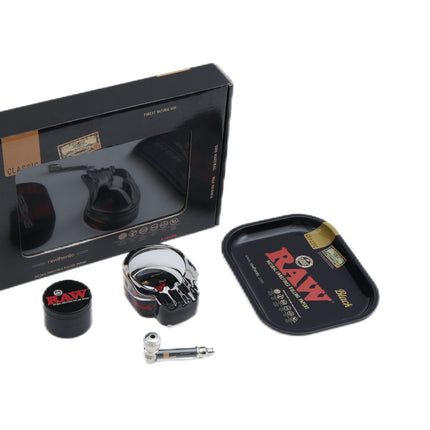 4-piece smoke kit in black window box with metal grinder, jar, and RAW rolling tin