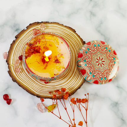 Rose soy scented candle in round votive tin with lid beside, wax with floral petals
