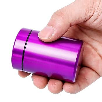 Purple metal storage jar with screw-top lid held in hand.