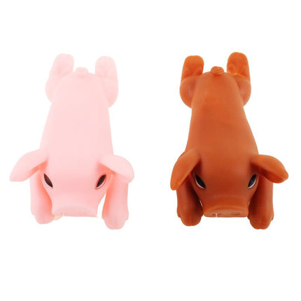 Squeaky pig dog toys, orange and pink plush pigs with black eyes, close view