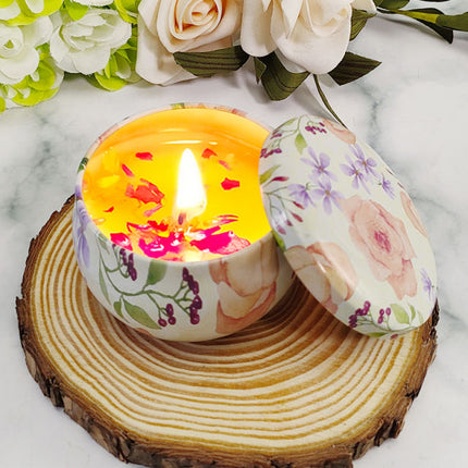 Floral votive soy candle with lit wick, decorated tin and open lid