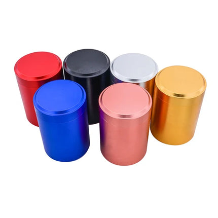 Set of metal storage jars with flat screw-top lids in red, blue, black, white, and gold.