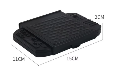 Black plastic Battlevessel board game case with studded grid and sliding compartments
