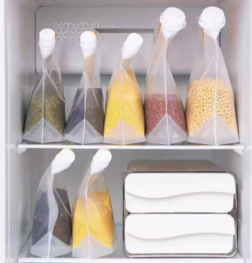 Set of clear foldable liquid bags with white spout caps and orange handles