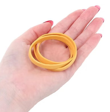 Yellow thick rubber band rings held in hand, 6mm