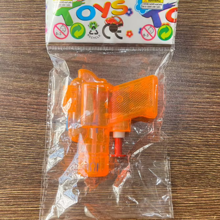 Orange plastic water toy gun in clear retail package