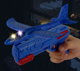Blue toy glider launcher with speckled glider plane and glowing light effects