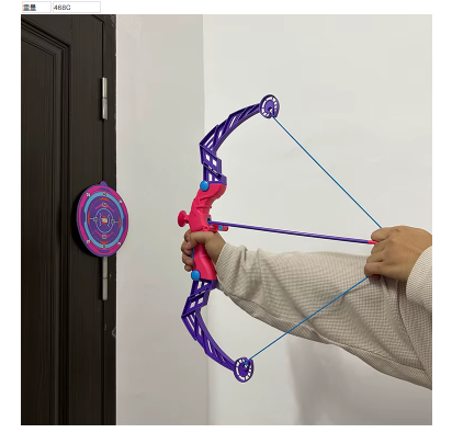 Toy archery bow with purple frame and red grip, held by hands near wall