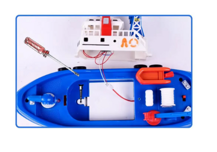 Blue toy rescue boat interior with open battery compartment and visible wiring
