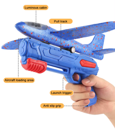 Toy glider launcher held in hand with speckled blue glider and trigger grip